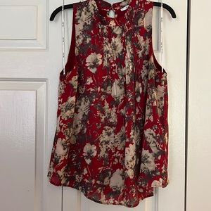 Red, floral, sleeveless blouse.